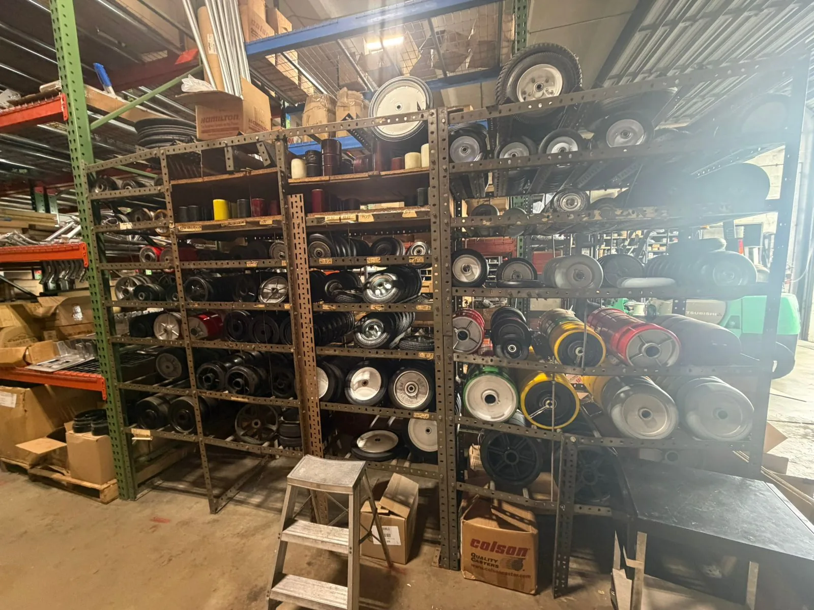 DECO legacy caster wheels stocked on warehouse racks at Douglas Equipment Miami — 1,551 part numbers still supplied